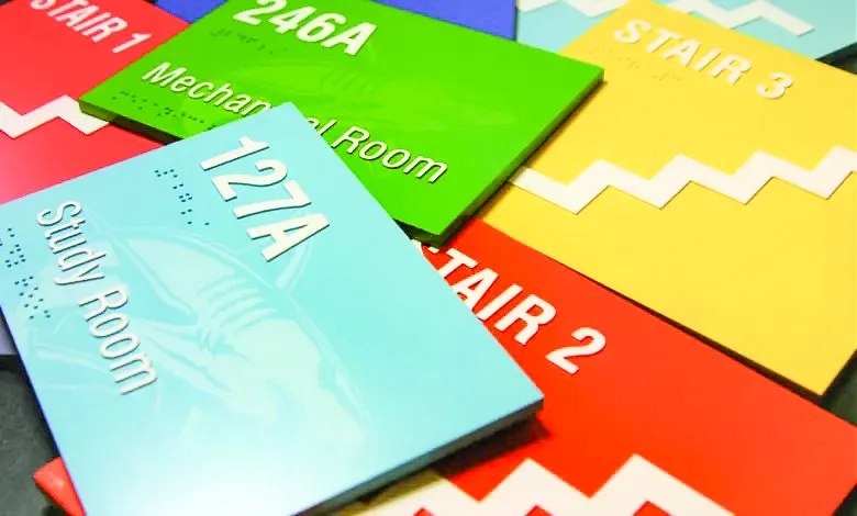Colorful indoor room signs with Braille text in various bright colors
