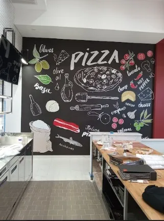 Martino Signs Philadelphia interior with chalkboard pizza menu and kitchen workspace