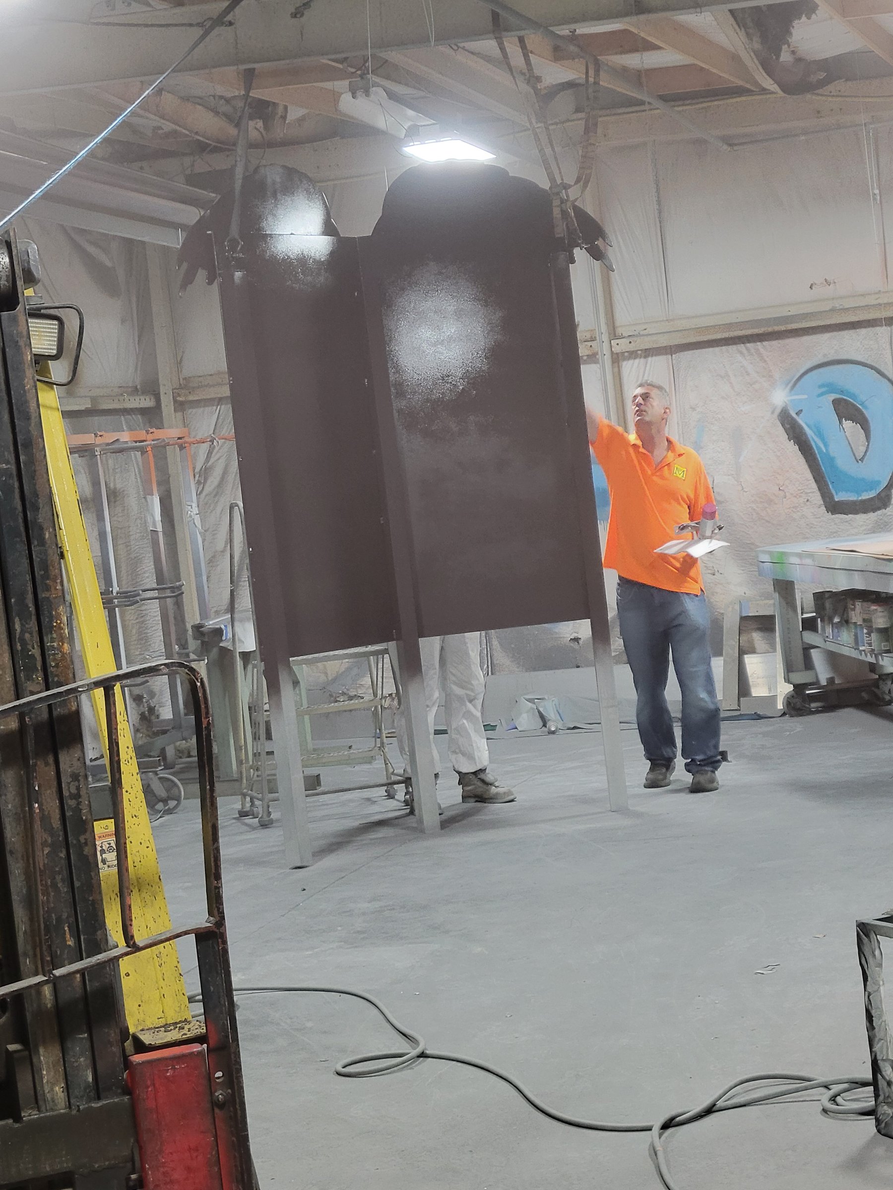 Painted panel hanging in the Martino paint booth