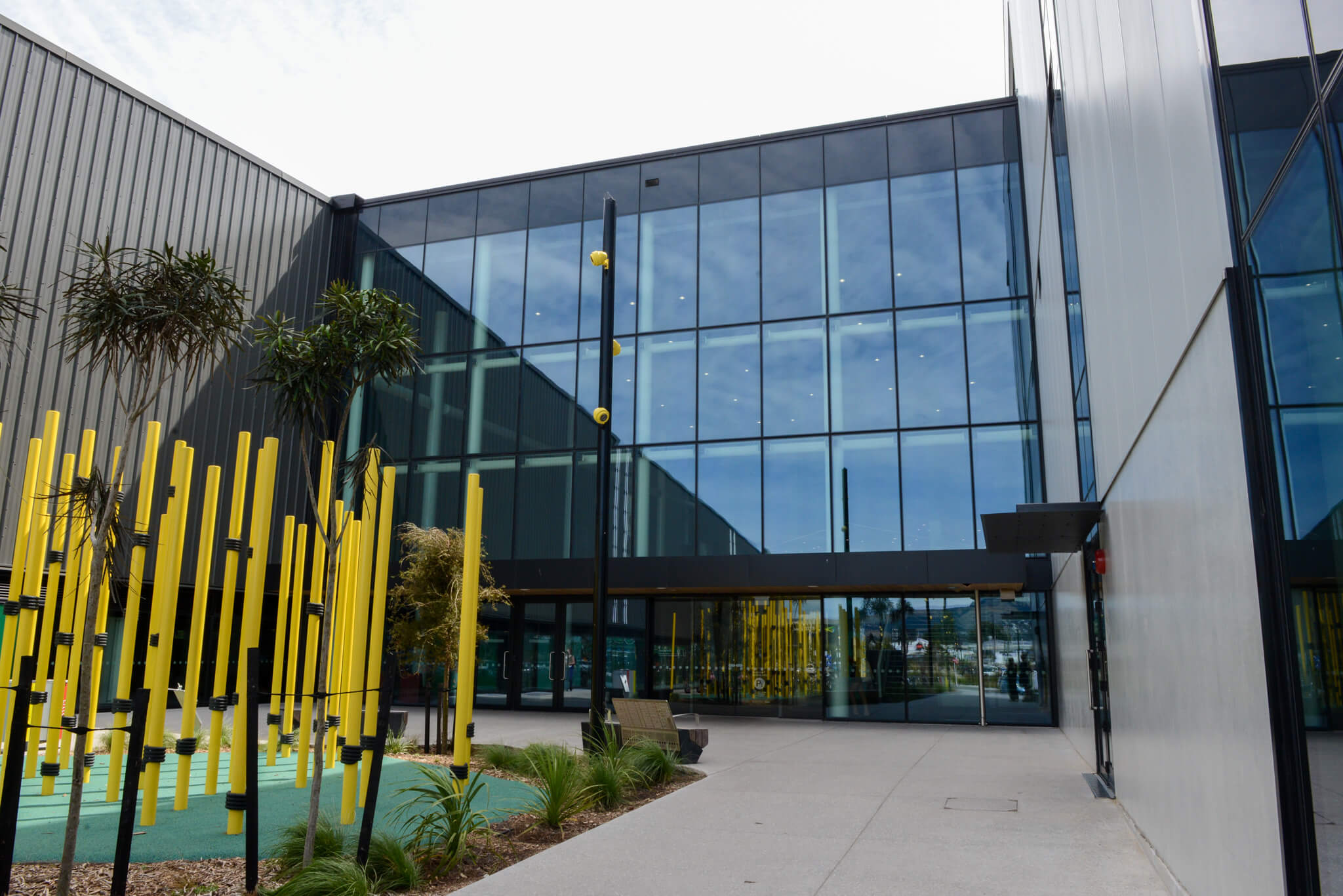 Modern building entrance with pillars and sign reading Nazareth House during dusk.