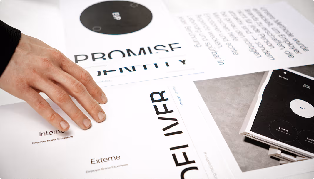 Close-up of hands arranging printed typography and branding documents