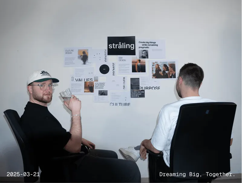 Group meeting around presentation wall 