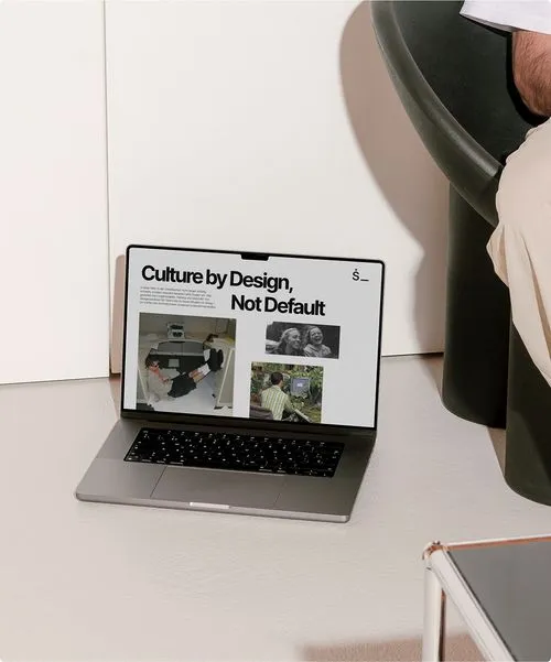 Laptop displaying design portfolio on minimalist desk