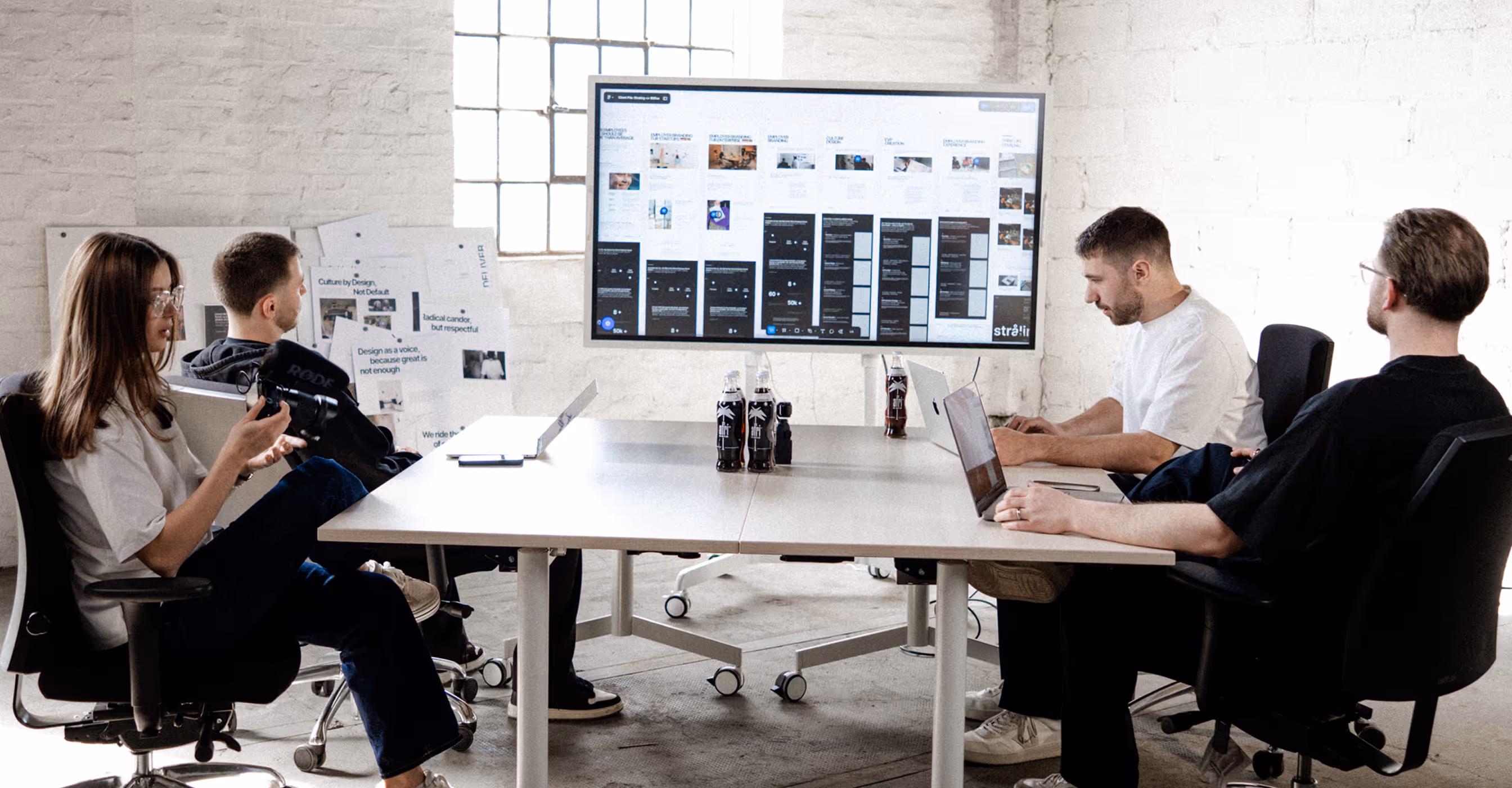 Team meeting in bright modern office with presentation screen