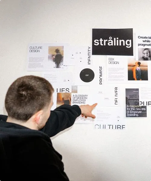 Person pointing at organized visual board