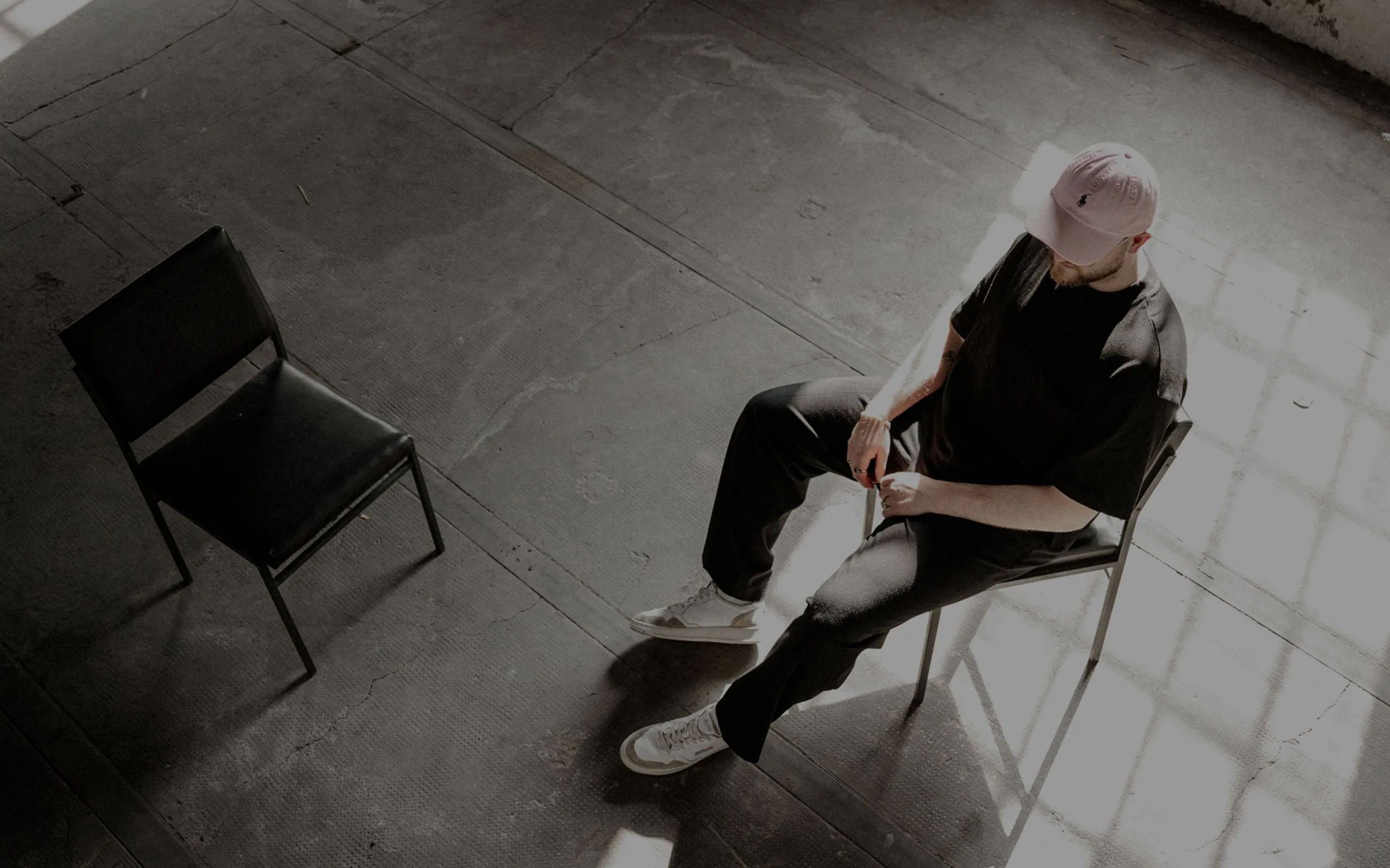 Overhead view of person sitting on chair in minimalist space
