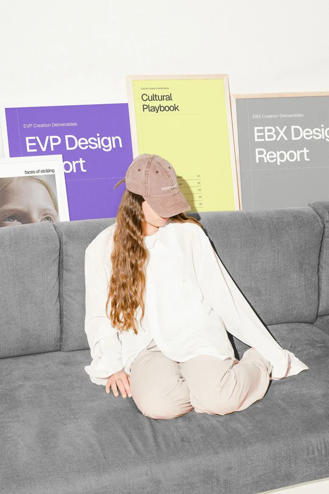 Person in white holding colorful documents