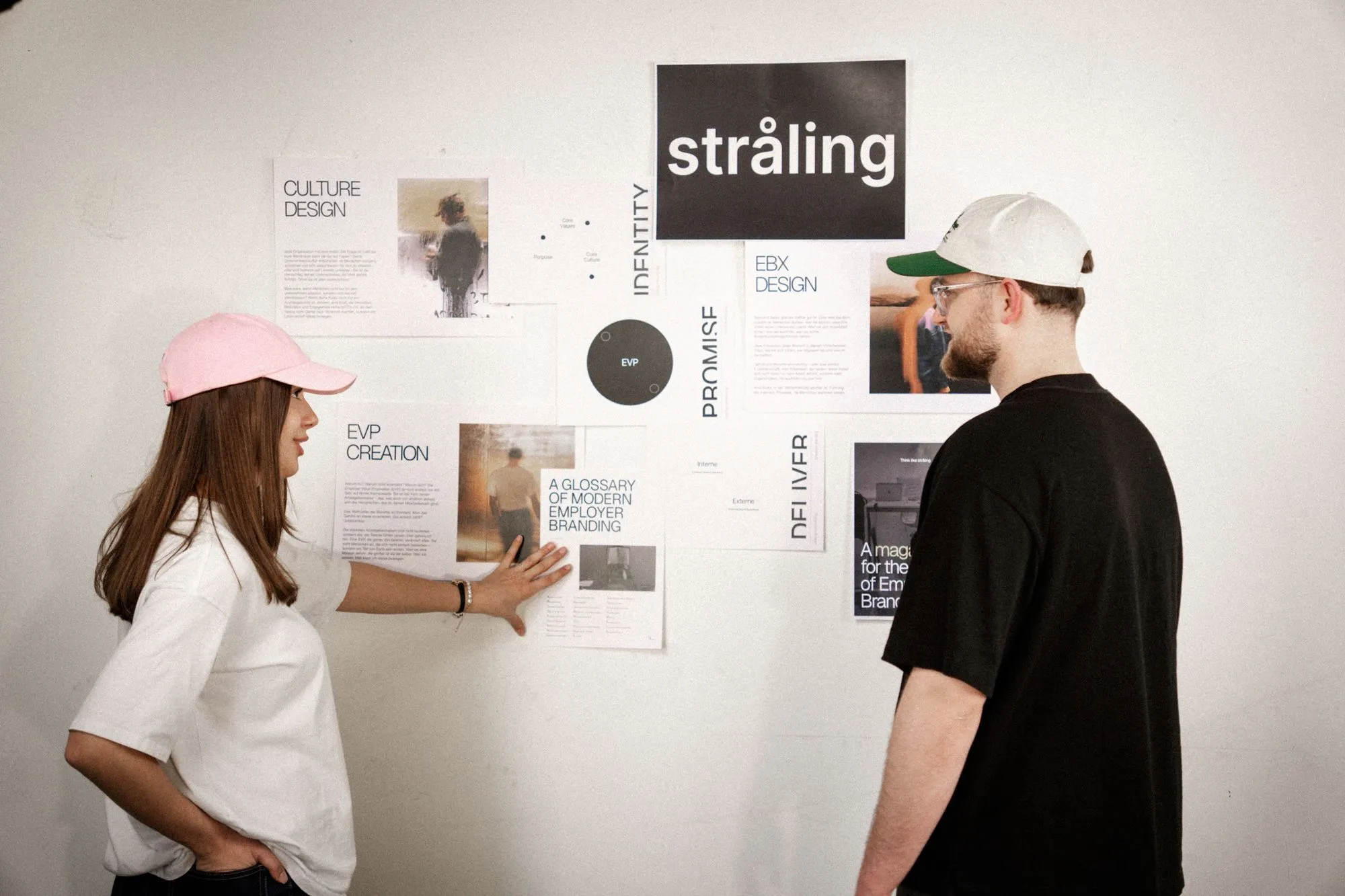 Two people collaborating at presentation wall