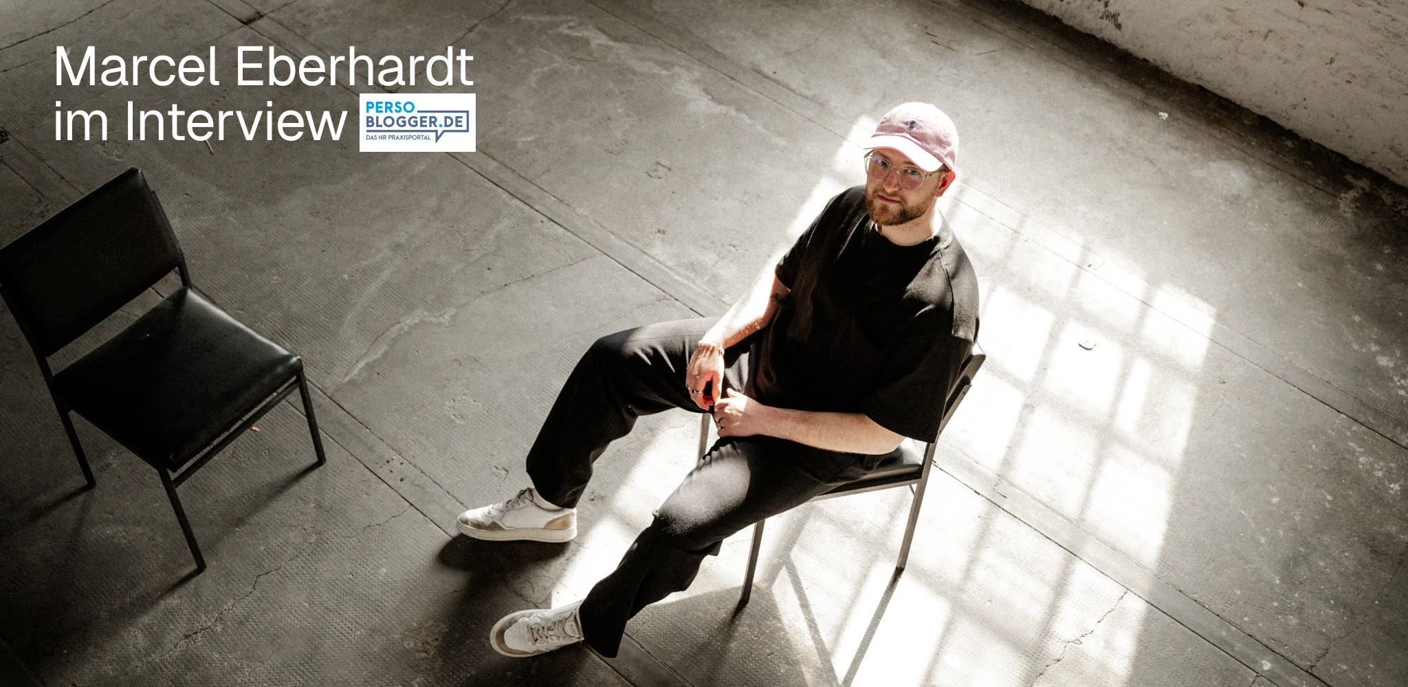 Marcel Eberhardt, Gründer der Employer Branding Agentur stråling, im Interview mit Persoblogger.de – Portrait vor Wand mit stråling Employer Branding Konzepten