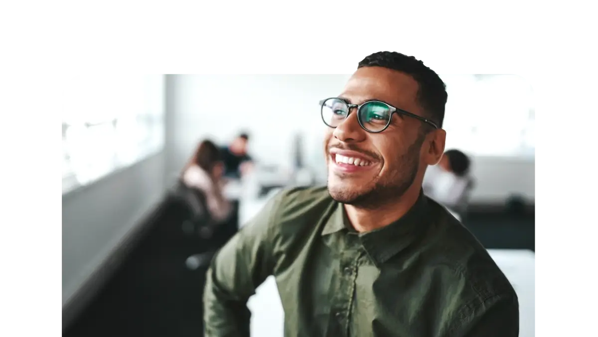 An individual smiles, looking off into the distance