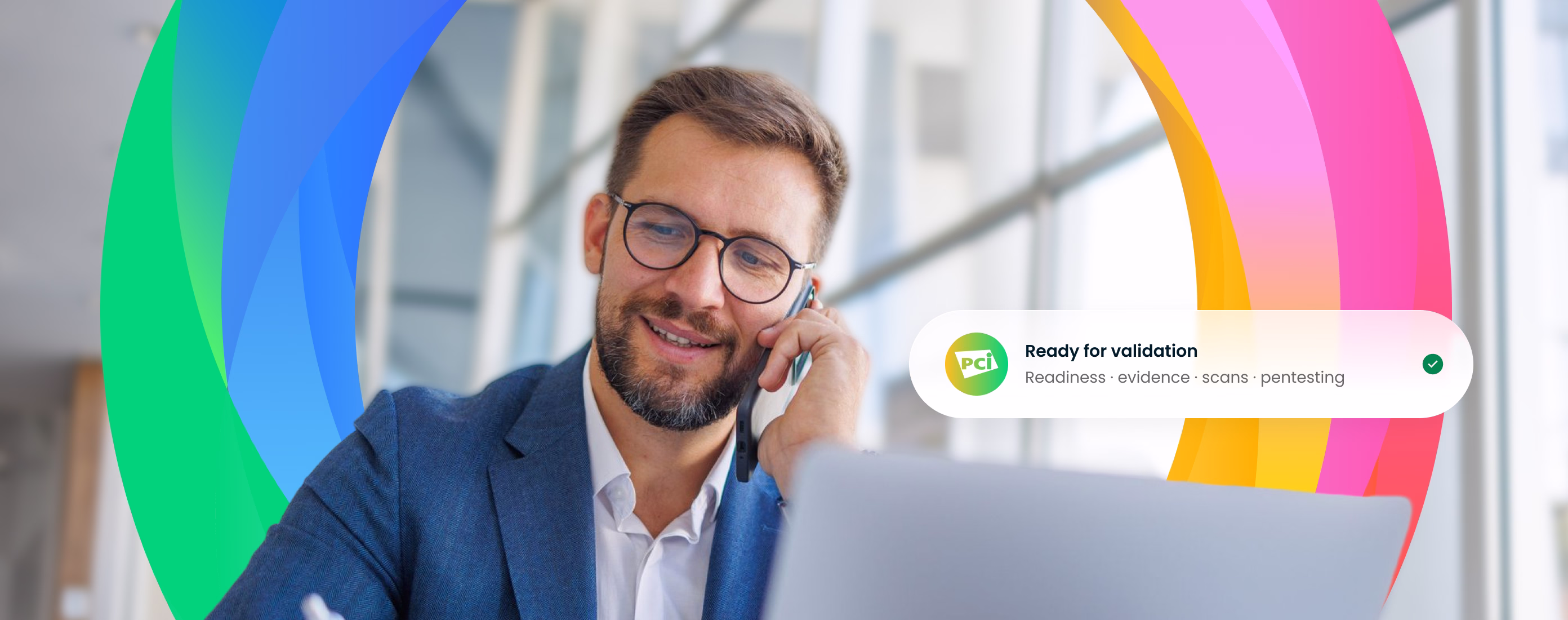 Man with glasses and beard in a blue suit speaking on a phone while looking at a laptop, with colorful curved shapes behind and a message saying 'Ready for validation: Readiness, evidence, scans, pentesting' with a green check mark.