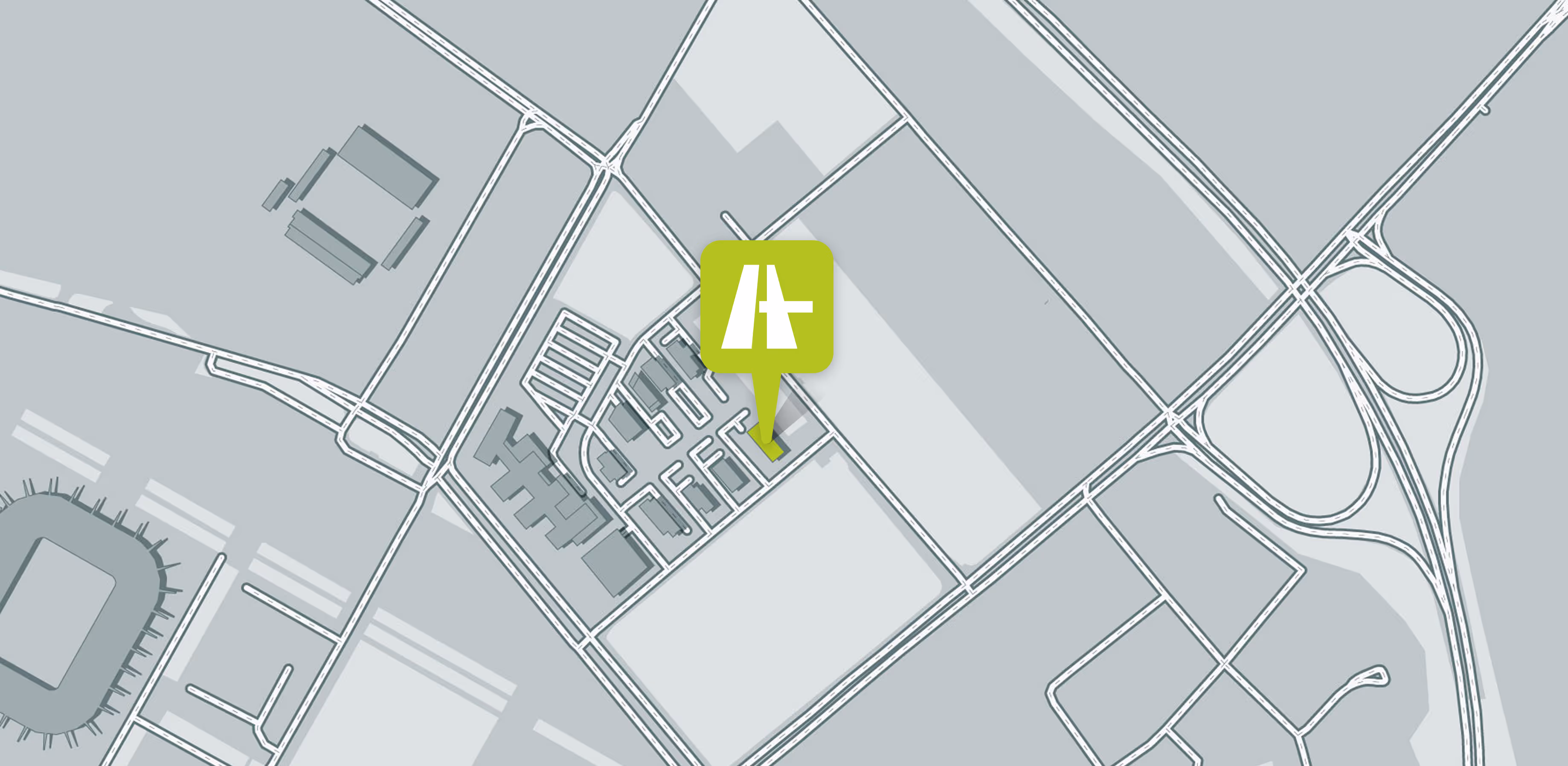 Karte mit grünem Automobilsymbol, das einen Standort in einer urbanen Gegend markiert.