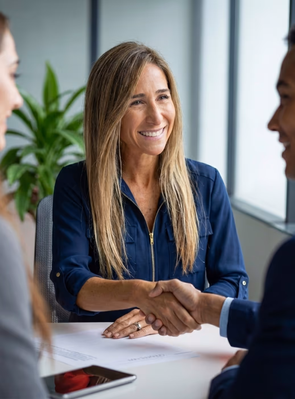 Denette Miller shaking hands with new clients. AOG Group | Allstate