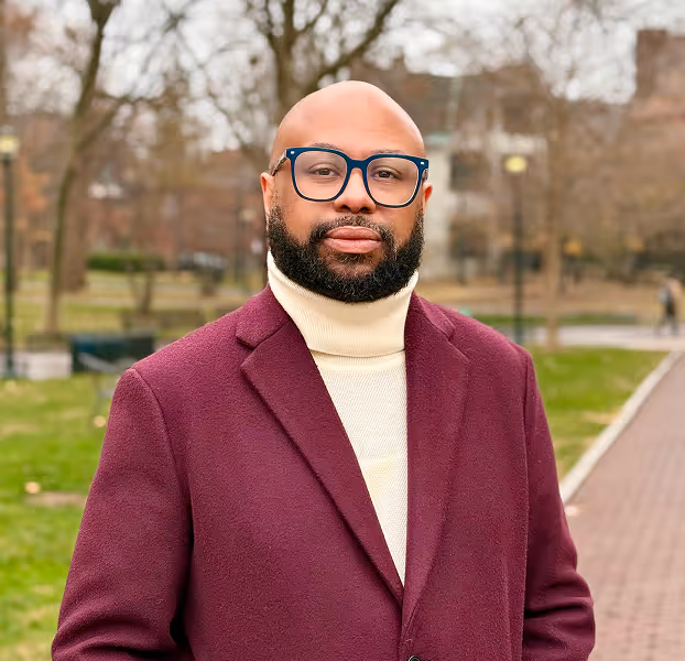 Desmond Upton Patton standing outdoors, leading efforts in social media trauma support and equity in AI.