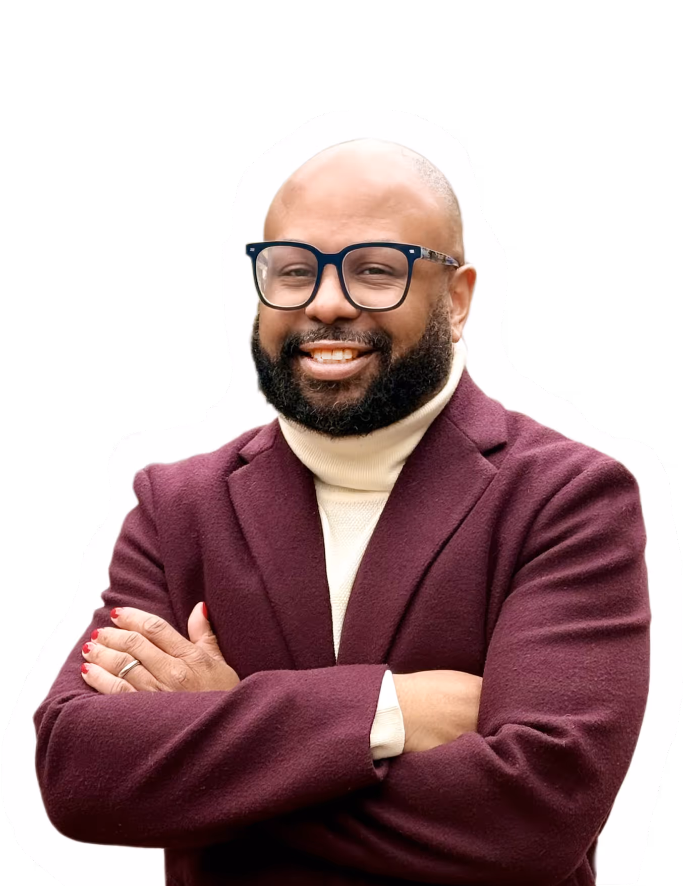 Desmond Upton Patton smiling on campus walkway, promoting joy and resilience through trauma-informed research.