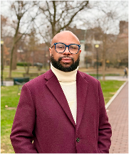 Desmond Upton Patton standing outdoors, leading efforts in social media trauma support and equity in AI.