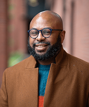 Desmond Upton Patton in brown coat, focused on AI and social work for online grief and loss support.