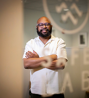 Desmond Upton Patton standing confidently in SAFELab, advancing digital empathy and youth digital experiences.