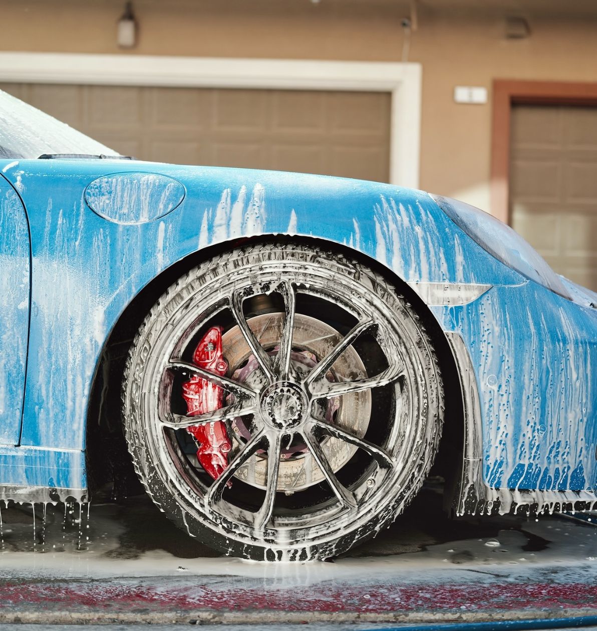 Blue Porsche receiving exterior hand wash by Luxe Detail in Auckland.