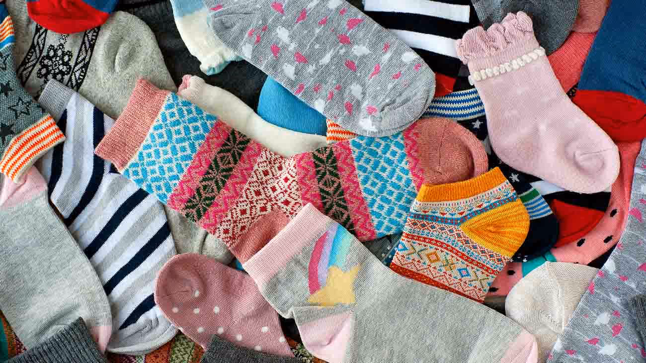 Sock recycling program displaying collected footwear and hosiery