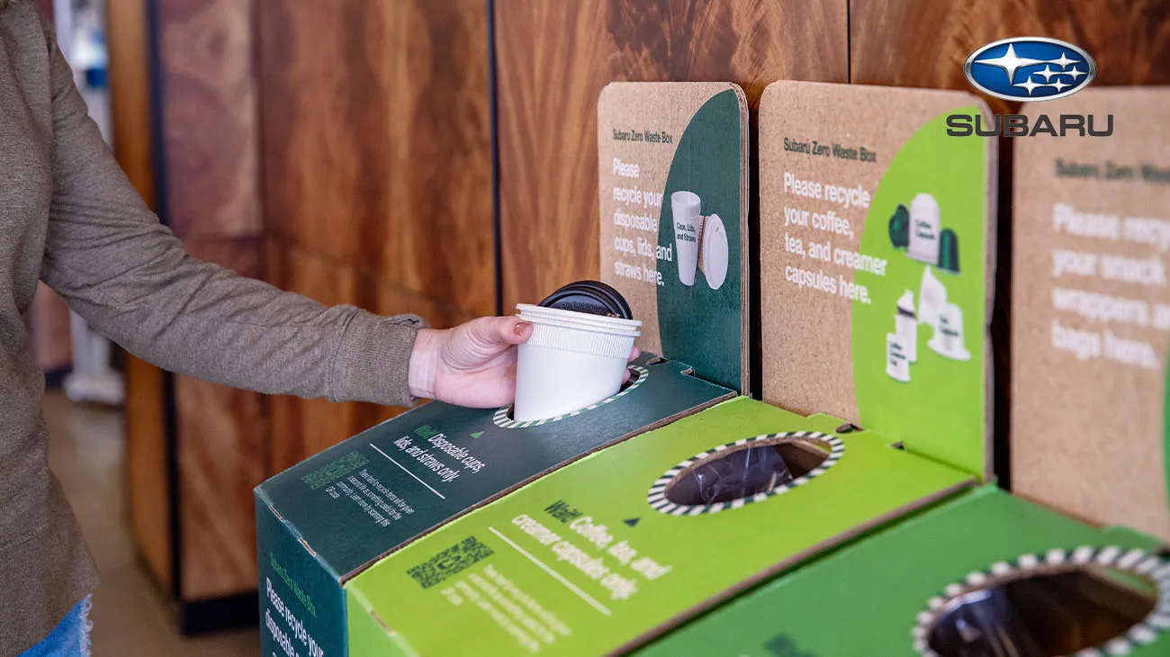 Signage at a Subaru dealership explaining the recycling program for car parts and packaging through TerraCycle.