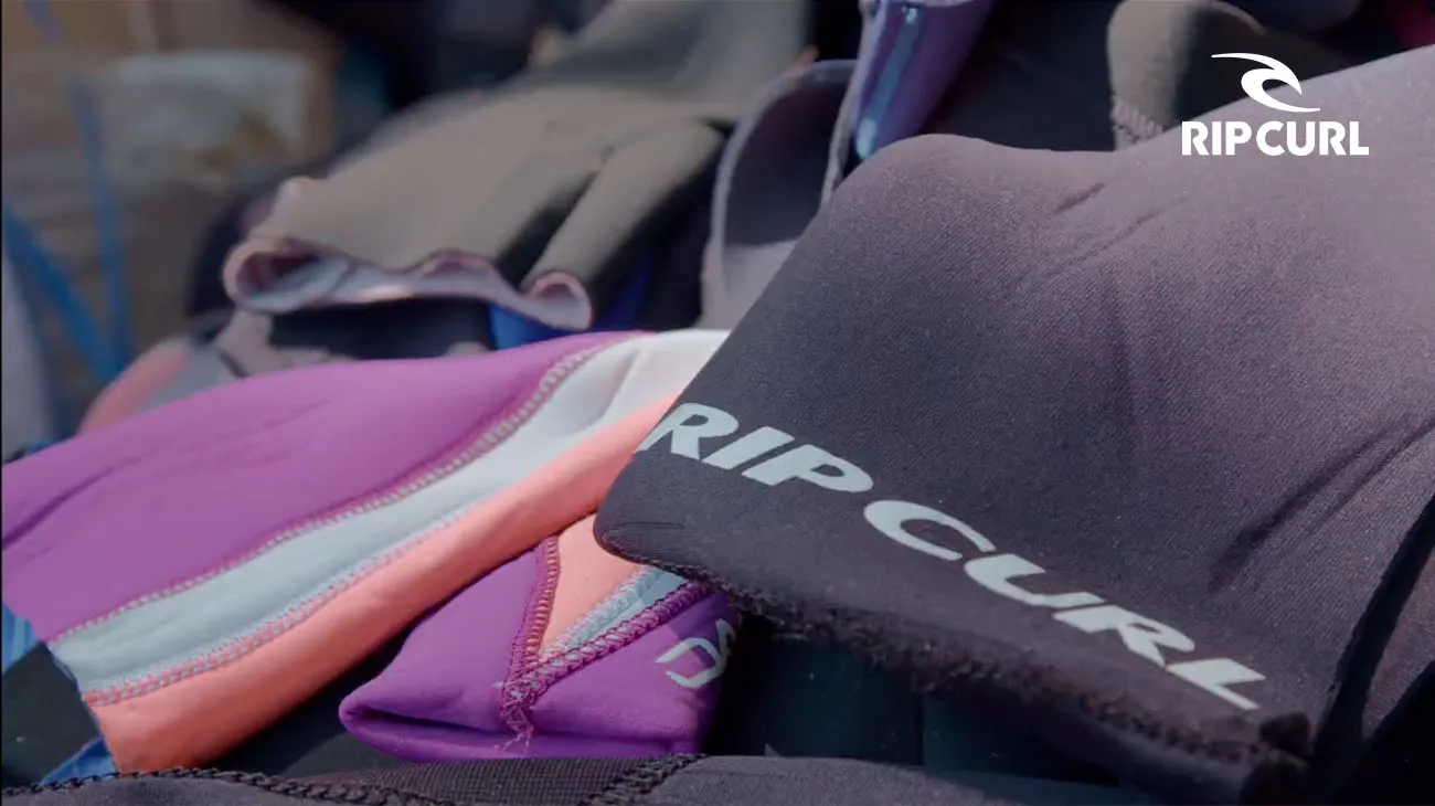 A person wearing Rip Curl apparel, highlighting the brand's commitment to sustainability through its recycling program with TerraCycle.
