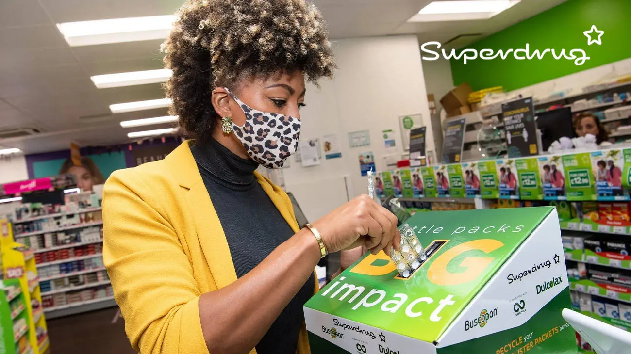 An in-store recycling bin at a Superdrug location for collecting empty makeup and skincare containers.