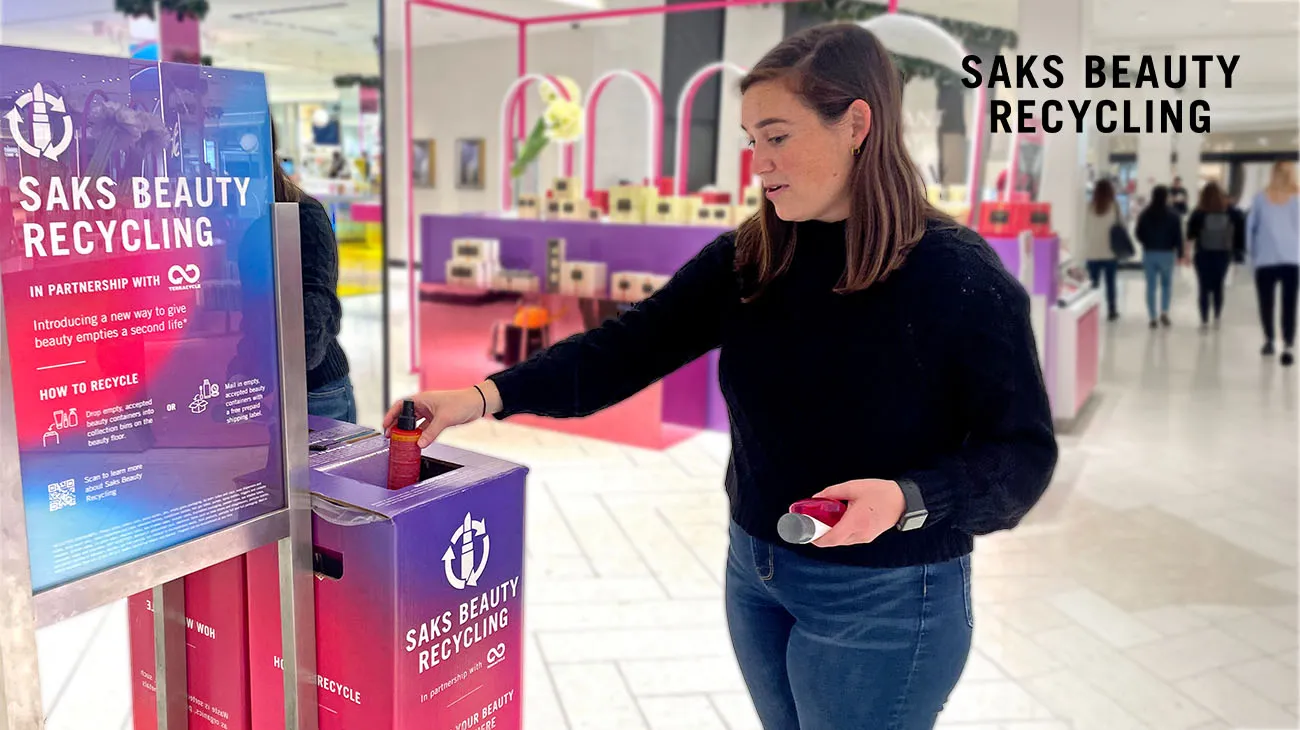 A beauty consultant at a Saks Beauty counter explains the in-store TerraCycle recycling program to a customer.