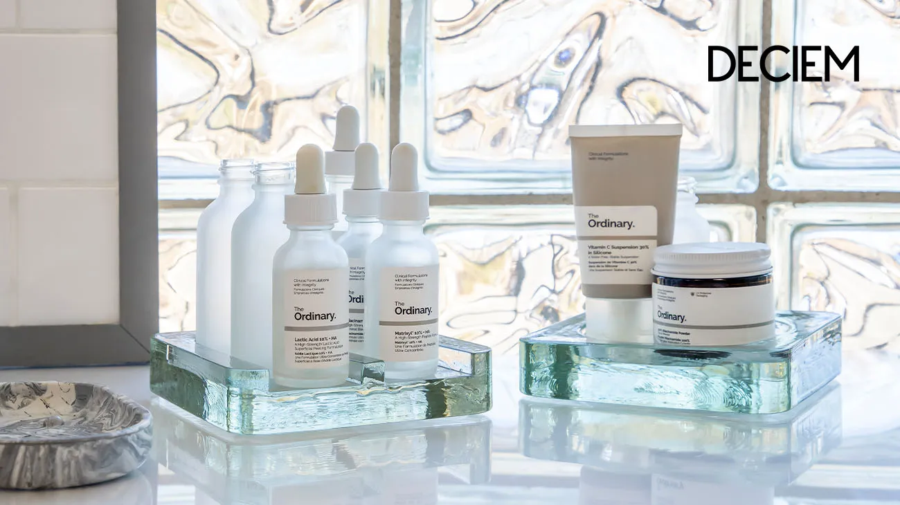 Empty skincare bottles from Deciem, collected in a clear bag for TerraCycle's beauty product recycling program.
