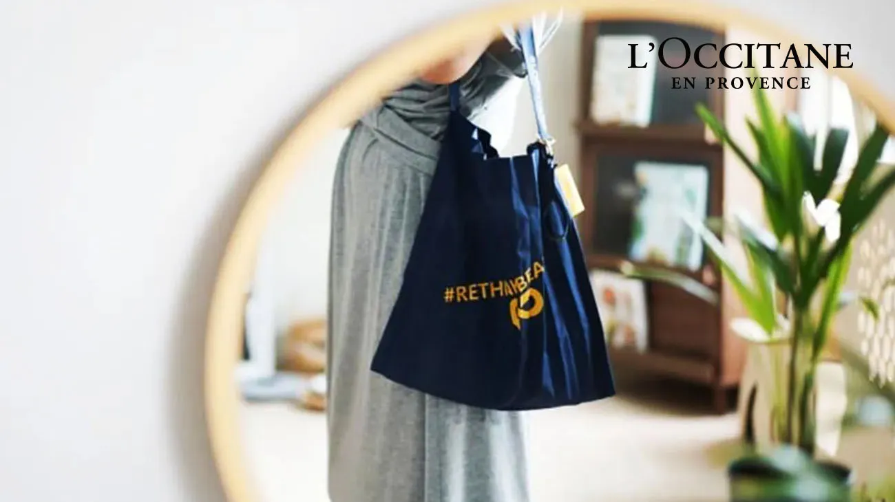 Empty L'Occitane beauty product tubes and containers, ready for recycling in a TerraCycle collection box.