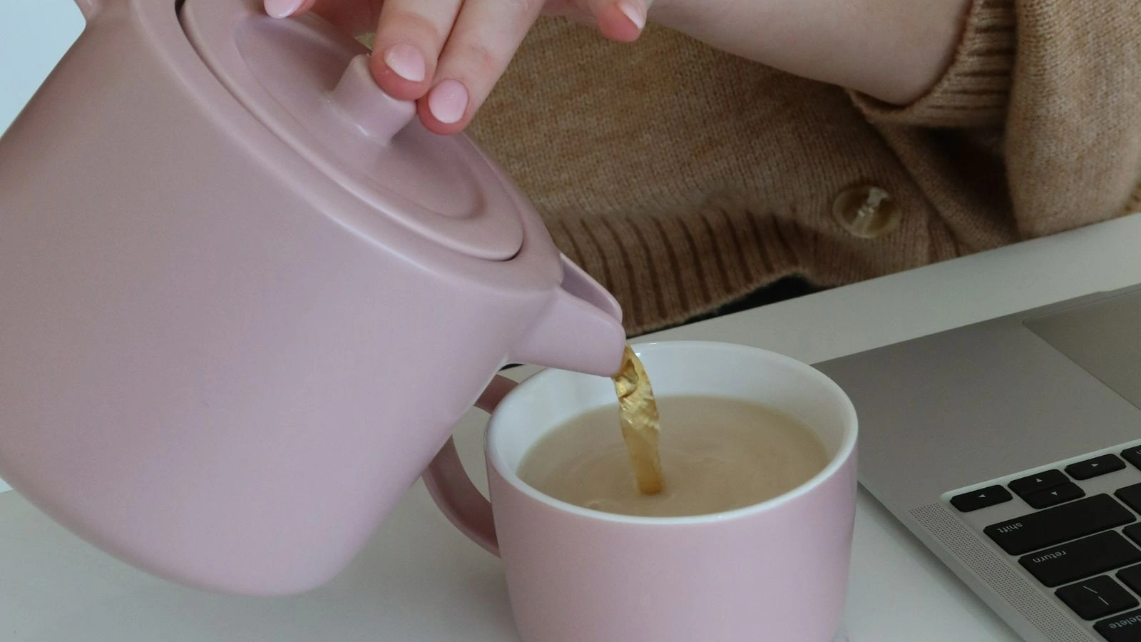 Closeup-shot of tea poured from a tea pot to a cup