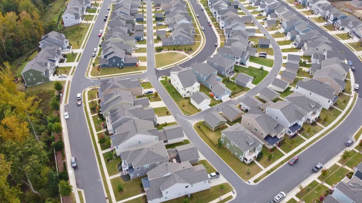 Paolo and Galiano Tiramani, a father-son duo, stand in a warehouse under construction with metal framing and a "STAGING" sign in the background.