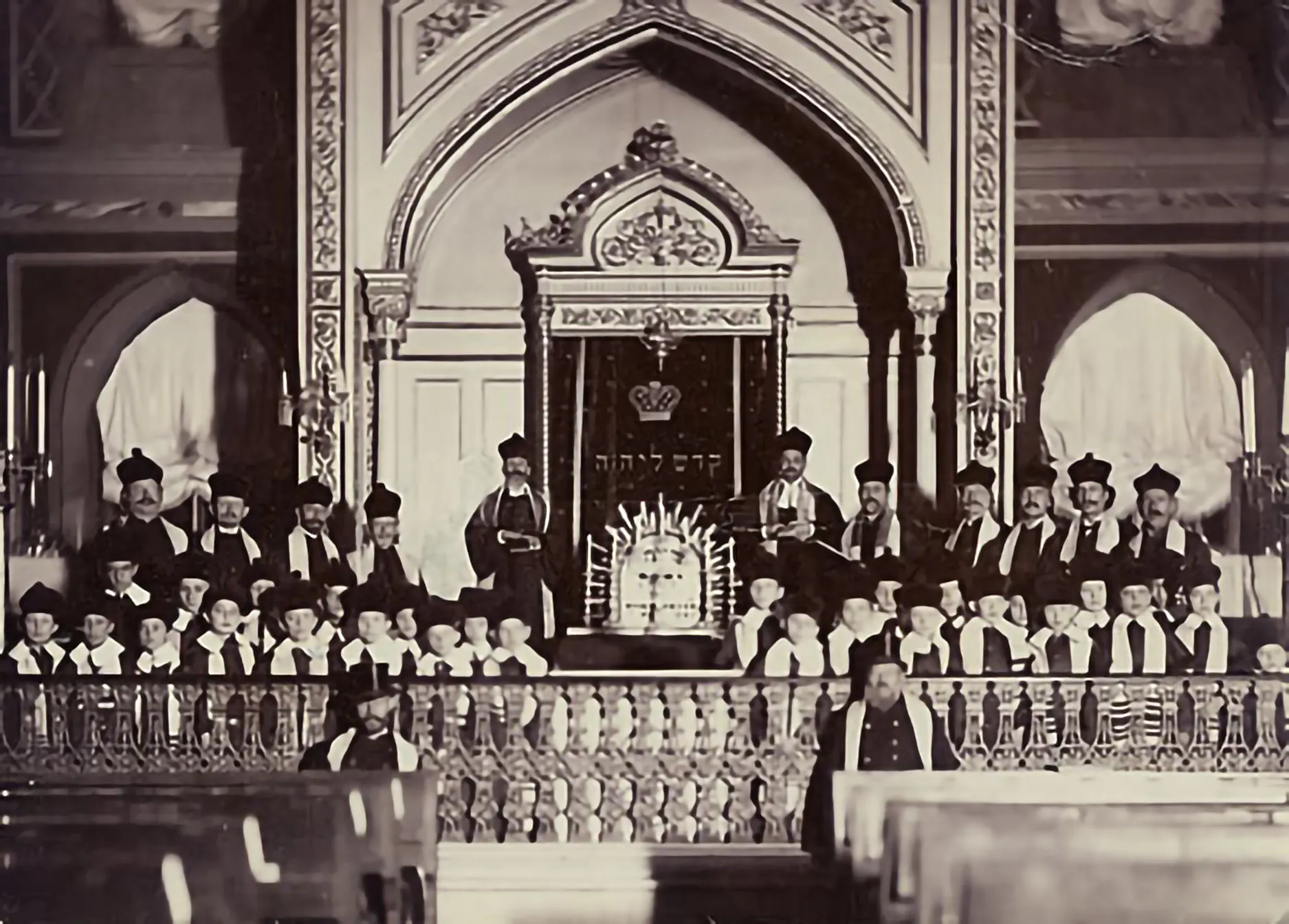Portrait of Cantor Pinchas Minkovski (back row, 6th from right) and the boys' choir in the Brody synagogue (built in the 1840s) in front of the ark. (Odessa, c. 1912)
