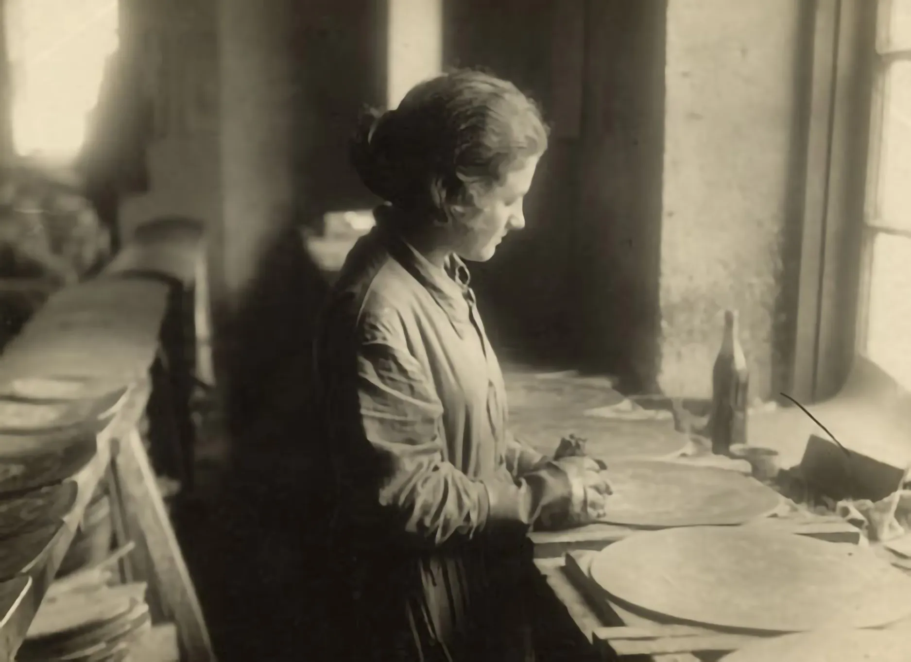 Portrait-study at a wood-working factory maintained by the local relief society: a woman manufactures decorated wooden chair-bottoms. (Odessa, c. 1934)