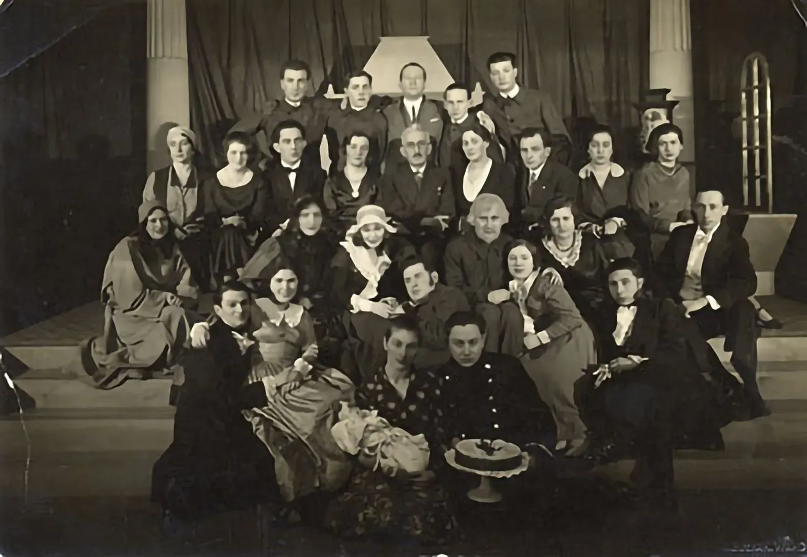 A group of actors and actresses of the Hebrew Theater posing in costume on a stage. Photo by Jan Bulhak. (Vilna, 1920's)