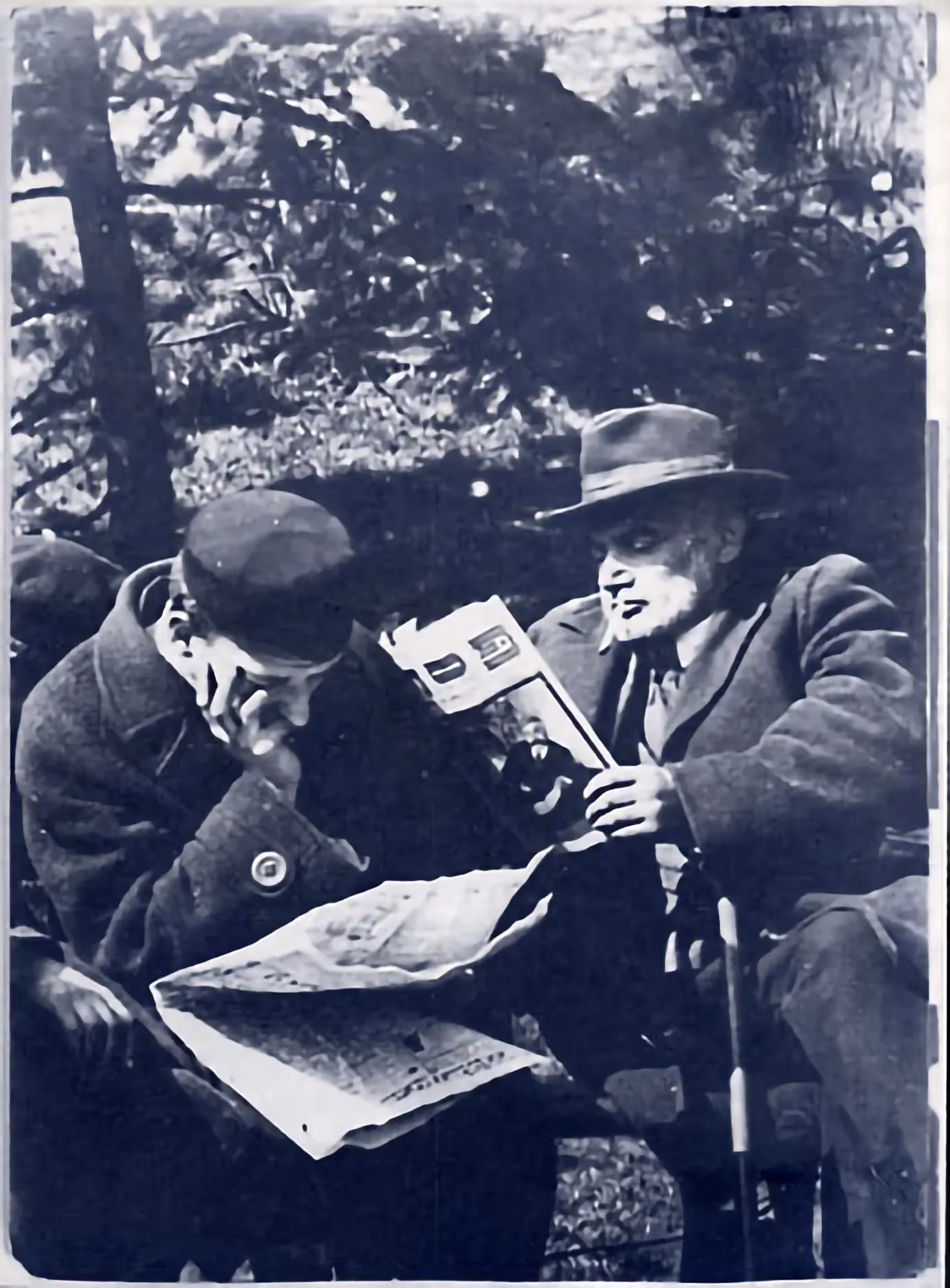 Jewish men sit on a bench in Krasinski Park