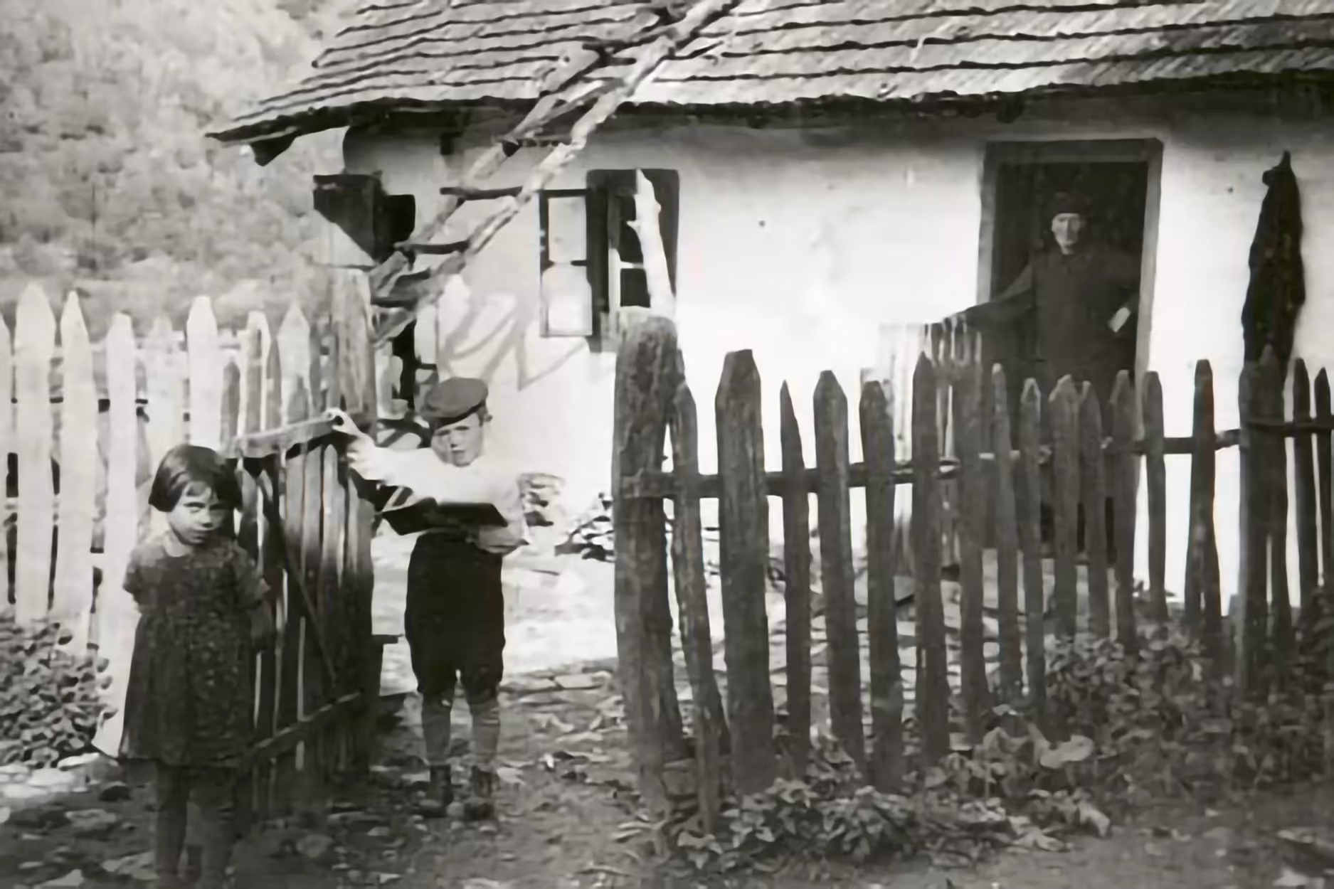 Woman and children in front of a village house (Carpathian Mountains, date unknown).
