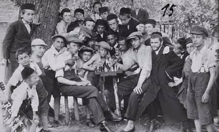 Orthodox Jewish boys stand by a chess board at a summer camp (Szczawnica, Poland, 1932).