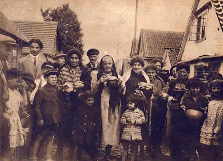 Women carry tsholent (a dish of meat, potatoes and beans) to the baker's oven on Friday afternoon