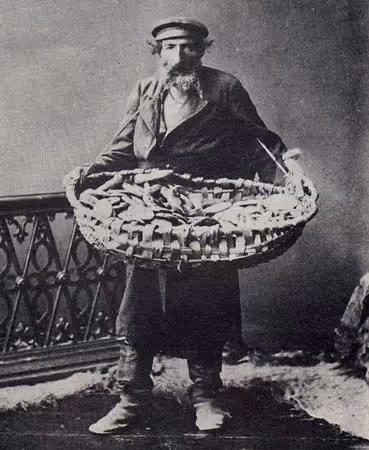 Studio portrait of a bagel vendor with a basket of his wares in Kishinev, Bessarabia (now Moldova) circa 1900.
