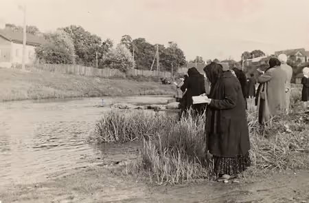 Women on a riverbank, performing tashlekh, a Rosh Hashanah ritual
