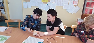 An image of two people working on a problem-solving exercise
