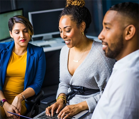 A photo of happy co-workers collaborating on a project.