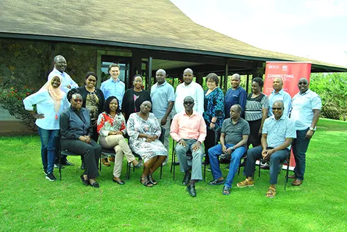 A group photo showing Tom Ravenscroft stood alongside members of the Kenyan National Examinations Council.