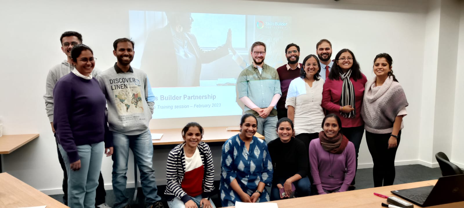Group of teachers from India smiling at the camera with James Prideaux of Skills Builder