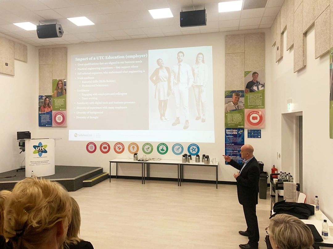 An image of Rob Skelland giving a presentation. On his slide he presents the impact of a UTC education from an employer's perspective.