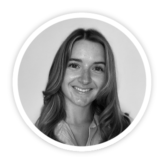 A black and white photo of Bethan Jeffers, Lead Associate at Skills Builder. She has long hazel hair, has a happy, warm smile and is wearing a pin-stripe shirt.