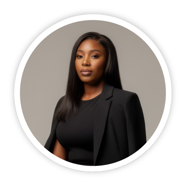 An image of Bella Bassey from Beautiful Brains Help Foundation, Nigeria. She is waring a sophisticated black office suit, with straitened black hair and is gazing calmly and proudly towards the camera.