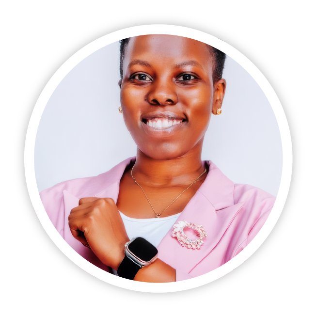 An image of Florence Thomas John from Asante Africa Foundation, Tanzania. She is wearing a pink blazer with a white tip and smart watch and is smiling brightly.