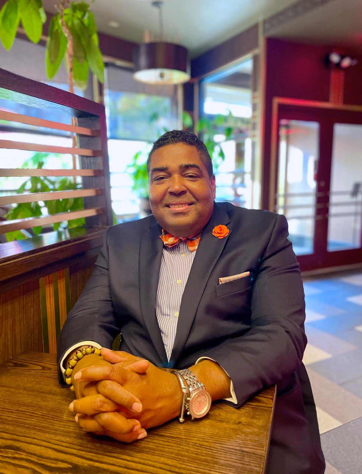 Professional staff member in suit with orange bow tie